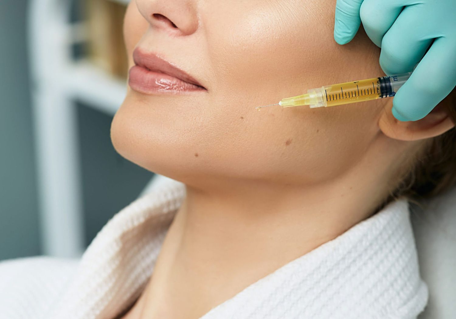 Adult woman while face plasmolifting at a beauty clinic. Cosmetology procedure for anti-aging effect on face skin